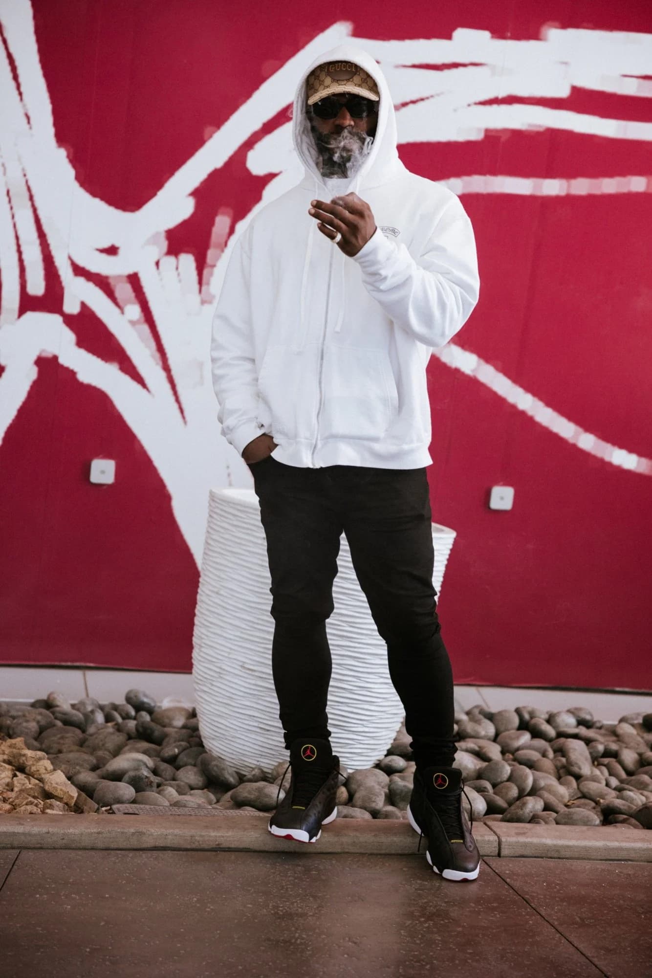 Street portrait, red mural with smoke